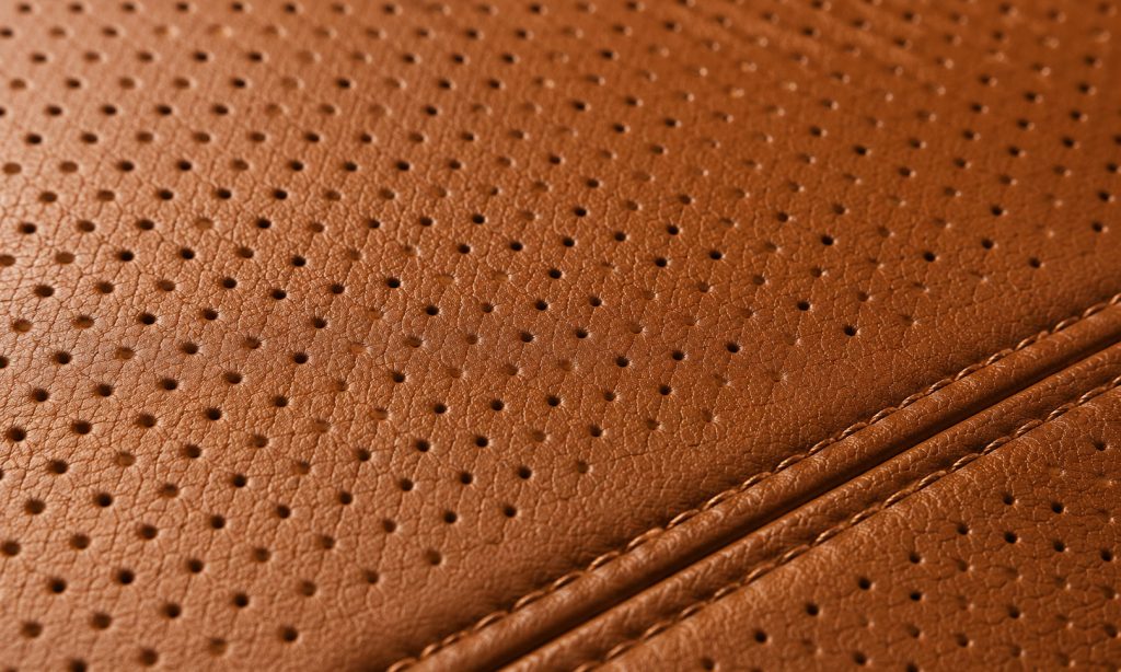 Perforation and stitching quality are quick visual cues to an automotive-grade cover.
